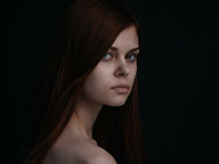 Fototapeta premium woman with bare shoulders glamor clear skin dark background
