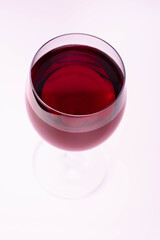 Red wine in a glass on a white background. Flat lay.