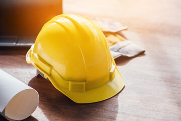 Yellow hard safety helmet hat for safety project of workman as engineer on together joining concept at construction site background. - obrazy, fototapety, plakaty