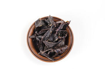 Dried dog treats in a brown clay bowl on a white background. Thi