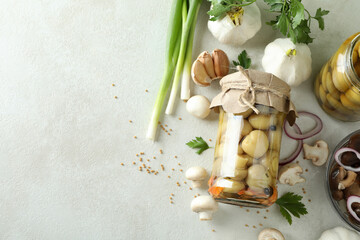 Concept of tasty food with marinated mushrooms on white textured table