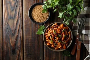 Concept of tasty food with marinated mushrooms on wooden table