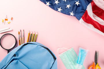 Back to school or college concept. Top view of school supplies stationery, American flag and surgical face mask, isolated on pink background, Back to education new normal during outbreak coronavirus