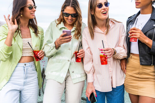 Happy Friends Cheering And Drinking Cocktails At Park Party Outdoor