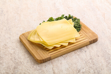 Sliced Gouda cheese over board