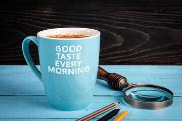 Good taste every morning. Coffee mug and magnifying glass on wooden table