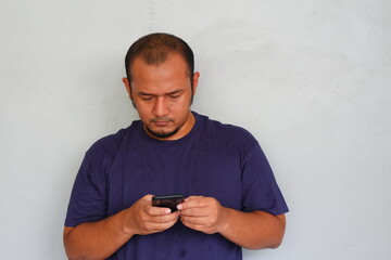 Young asian man is using smartphone