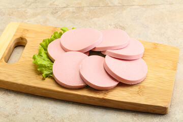 Sliced sausage snak over board