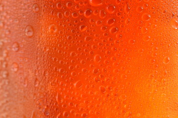 Black drop of orange-yellow water droplets