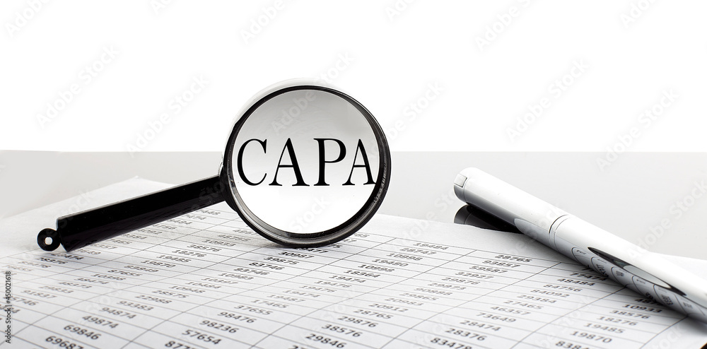 Poster magnifying glass with text capa on the background with pen