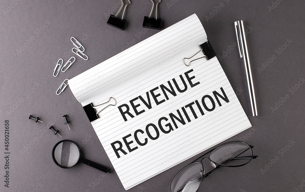 Aufkleber notebook with tools and notes with text revenue recognition , business concept