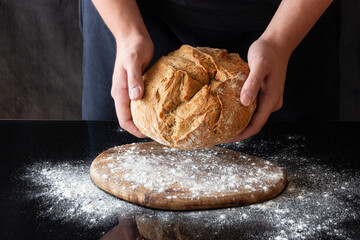 Baker presenting freshly baked Bread
