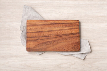 Wood cutting board on linen napkin