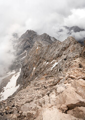 the famous Jubileumsgrat from Zugspitze to Alpspitze covered in clouds on an overcast but sunny day