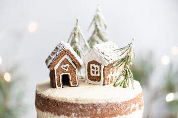 Christmas cake with gingerbread houses. New year card, selective focus