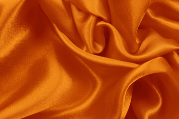 Fototapeta premium Orange fabric texture background, detail of silk or linen pattern.