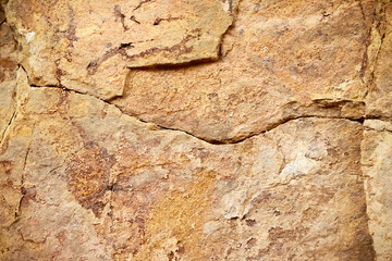Natural grunge brown rock texture with rough and line cracked