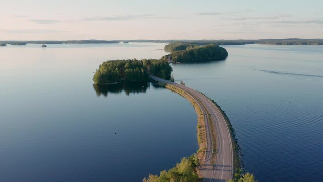Pulkkilanharju ridge road in P&auml;ij&auml;nne lake in summer in Finland.