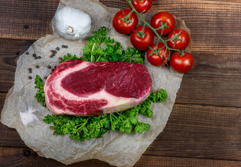 Fototapeta na wymiar Raw marbled ribeye steak and spices