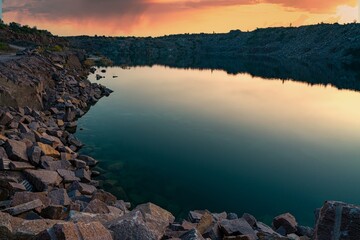 Small lake surrounded by stone waste from mine work