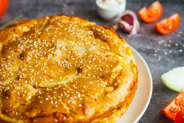 Chicken and potato pie. Tasty pie. Pie and vegetables on the table 