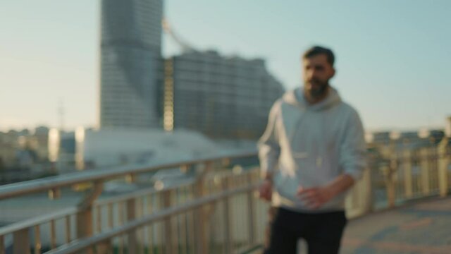 Athletic middle aged man relaxing after fast jogging