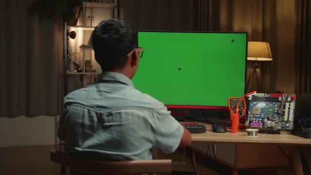 Engineer Asian Boy Is Working With Desktop Computer In Home, Mock Up Green Screen Display, Genius Children Concept
