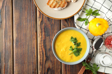 Concept of tasty food with pumpkin soup on wooden table