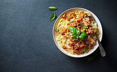 Spaghetti with Bolognese Sauce, Parmesan and Basil. Top view. Copy space