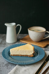 Bakery products. A piece of homemade cheesecake and a mug of coffee. Dessert.