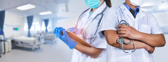 Team of doctors wearing masks with a stethoscope and a tablet at the hospital, health and medical concept.