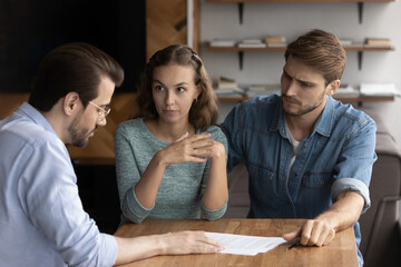 Couple of angry tenants having dispute with real estate agent, discussing complaint with lawyer,...