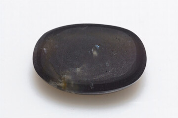 Natural stone scapolite cat's eye on a white background