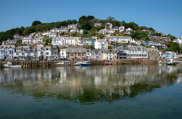 Fototapeta na wymiar West Looe, Cornwall, England, UK. Properties reflected in the Looe River on an incoming tide at West Looe a popular holiday resort.