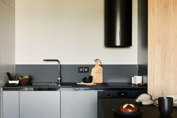 Stylish composition of modern small dining space interior. Black kitchen island and dining...