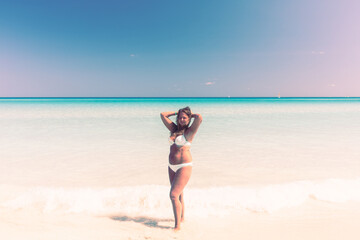 Fototapeta na wymiar Portrait of a tanned girl on the beach in a swimsuit