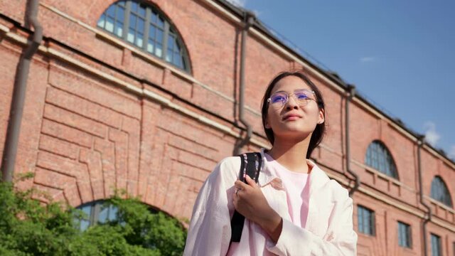 Portrait of asian university female student outdoor.