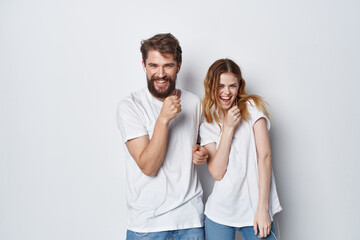 young couple in white t-shirts fun entertainment friendship positive