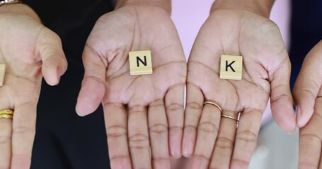 Hands holding wooden letters in the word 'thank you' show to camera. Concept of appreciate or gratitude for someone. Idea for good team work and colleagues in business office.