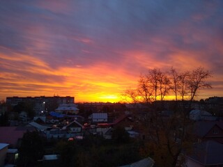 Fototapeta na wymiar beautiful sunset in the city with heavy orange clouds. High quality photo