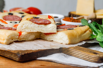 Cut Piece Of Creative Focaccia Pizza Inverted Pie Staffed Cheese And Food Art On The Top. Side View.