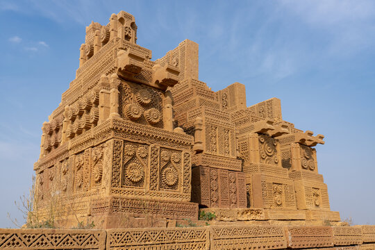 Group of ornate ancient early islamic carved sandstone cenotaphs or tombs on platform in Chaukhandi necropolis cemetery near Karachi, Sindh, Pakistan