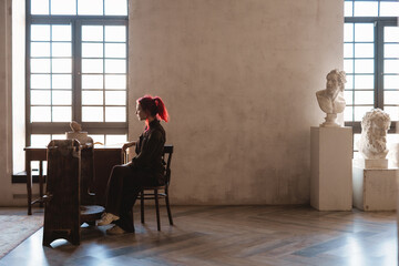 Young woman sculptor artist creating a bust sculpture