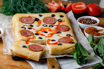 Cut Piece Of Creative Focaccia Pizza Inverted Pie Staffed Cheese And Food Art On The Top. Side View.