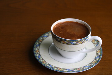 cup of coffee on wooden table