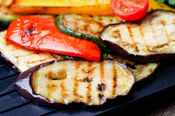 Grilled Vegetables Eggplant, Zucchini, Paprika, Tomatoes On Black Background. Close Up.