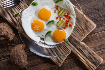 Fried eggs from two eggs on a plate, top view, healthy breakfast concept