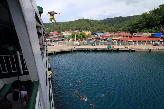 jumping from a ferry boat in Romblon, Philippines