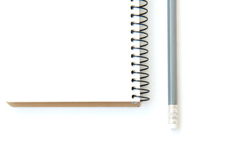 Open white notepad on spring and pencil isolated on white background with copy space. Business agenda.