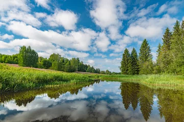 Photo sur Plexiglas Destinations Panoramic landscape of a calm river.A mirror image of Clouds and forests On the Lake.